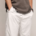 closeup person wearing white track pants