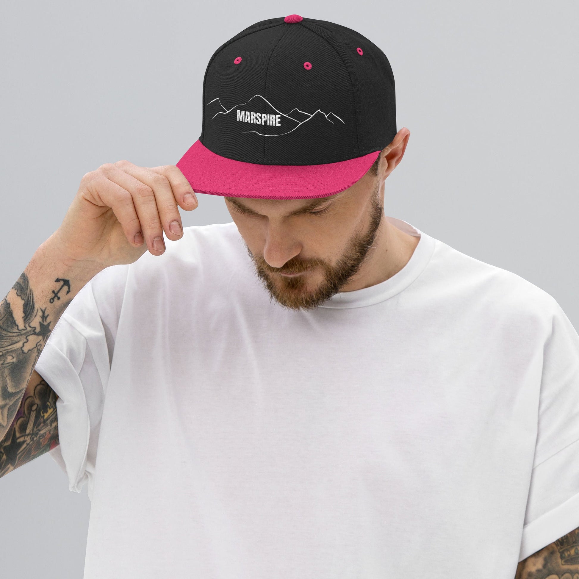 person wearing black & neon pink vintage snapback hat
