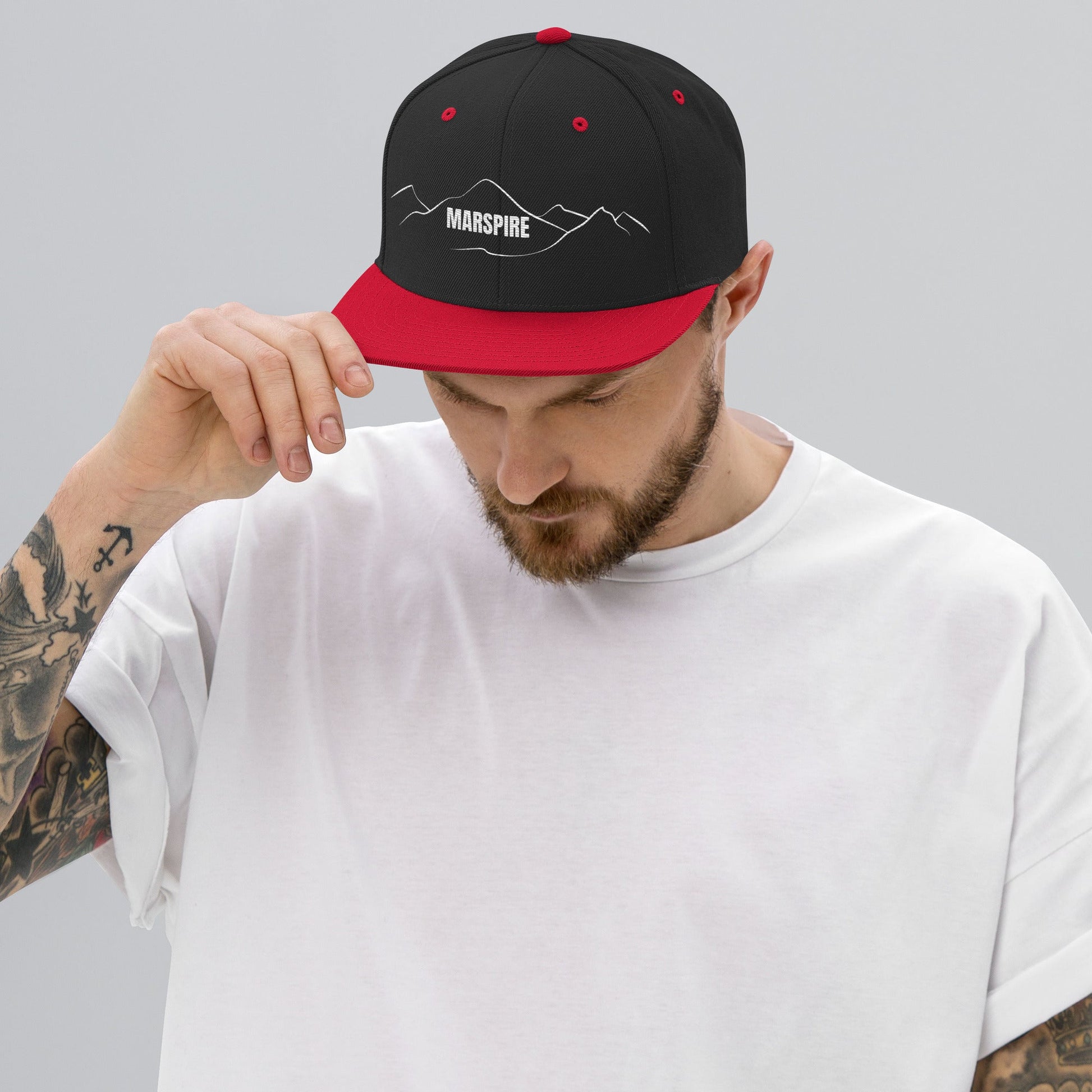 person wearing black & red vintage snapback hat