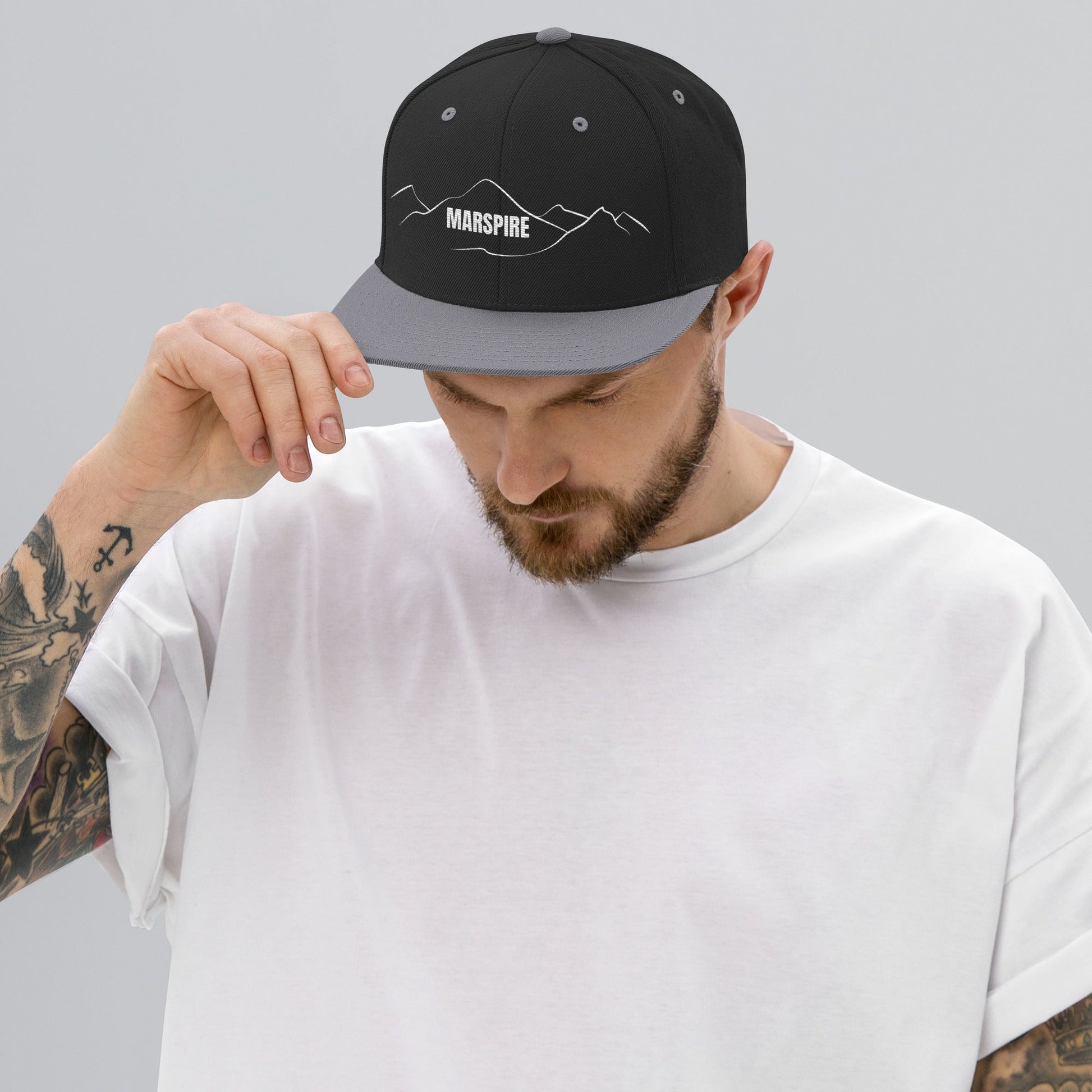 person wearing black & silver vintage snapback hat