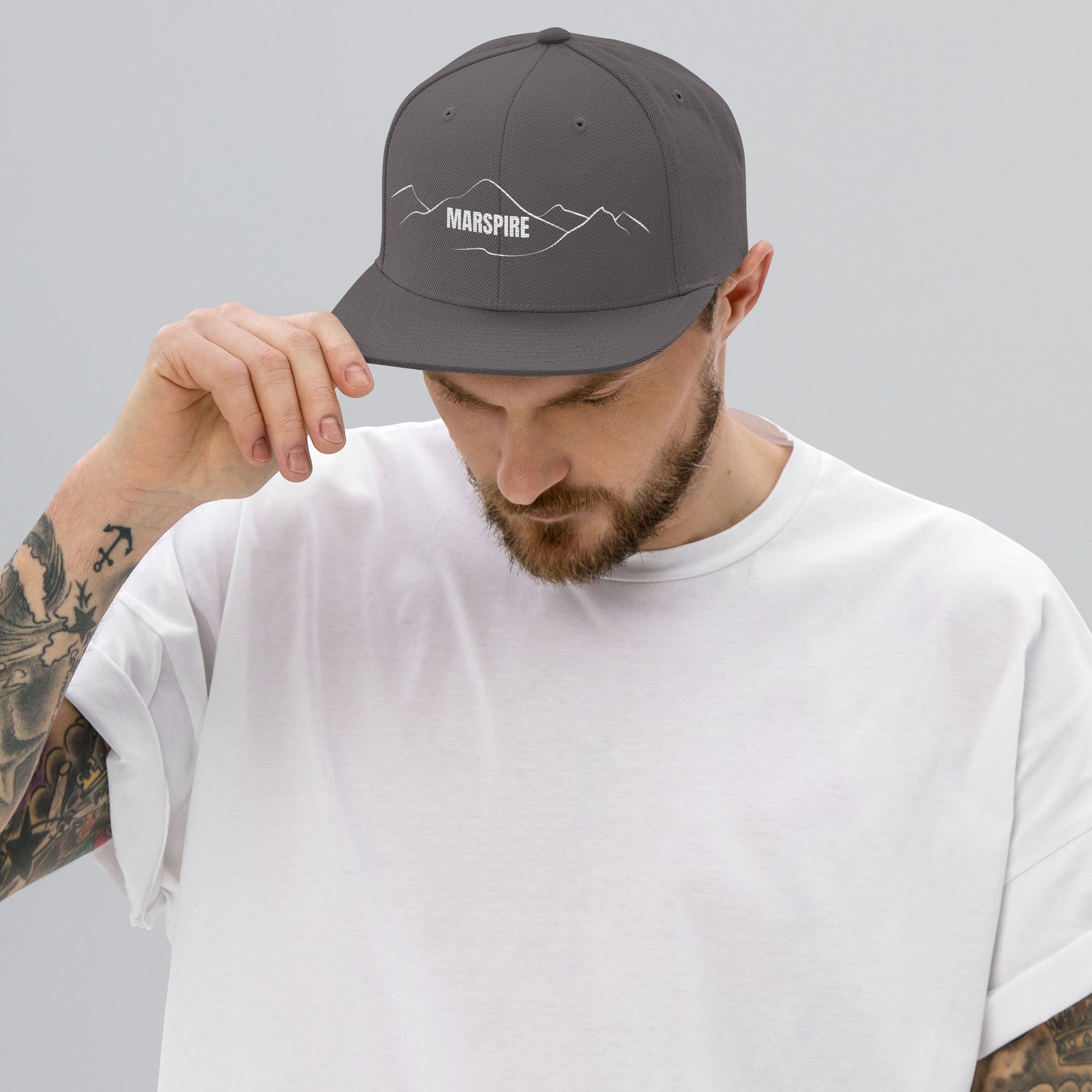 person wearing dark grey vintage snapback hat