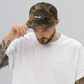person wearing green camo vintage snapback hat