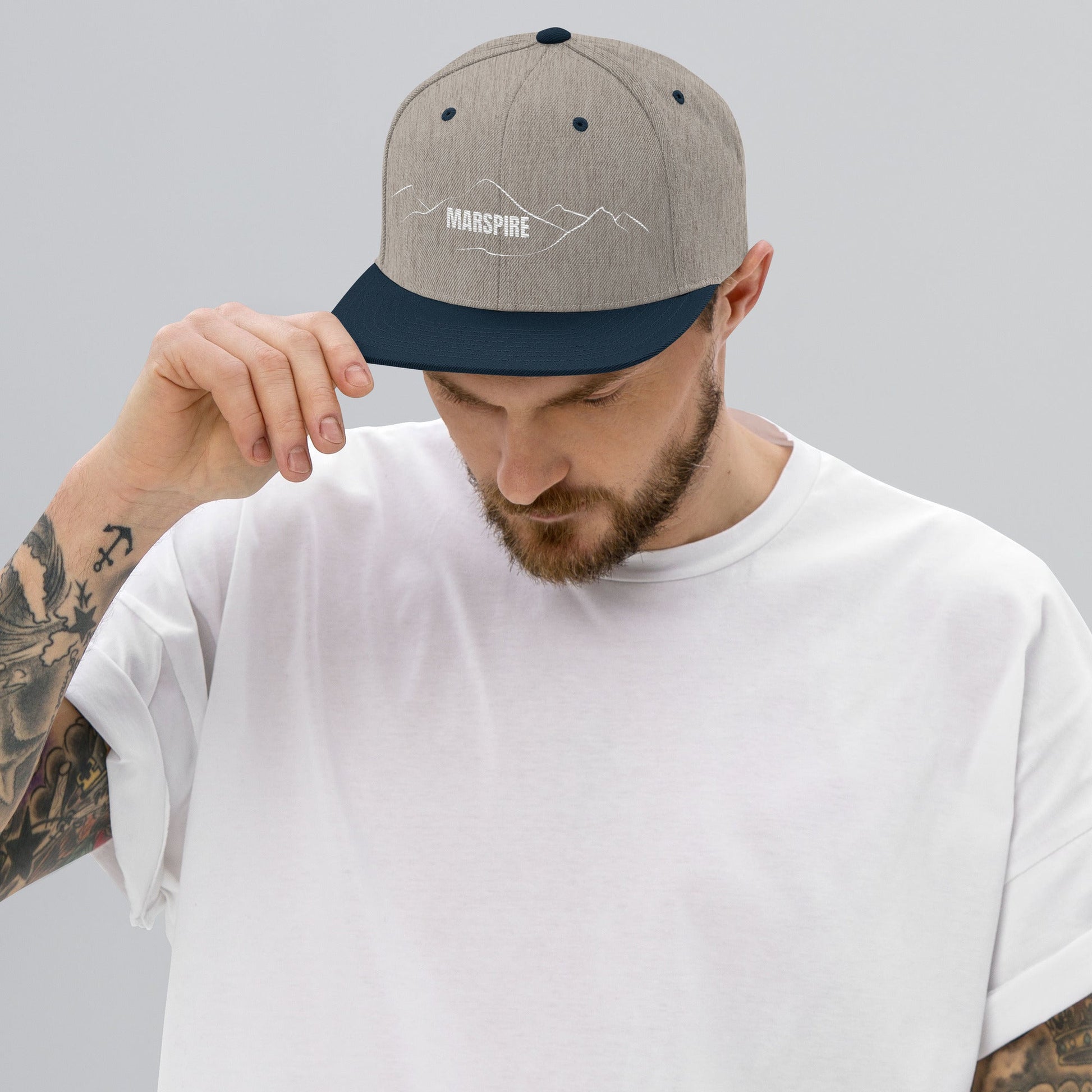 person wearing heather grey & navy vintage snapback hat