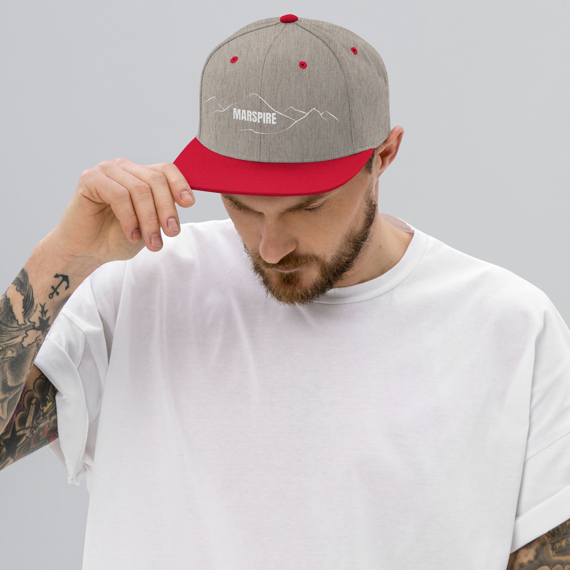 person wearing heather grey & red vintage snapback hat