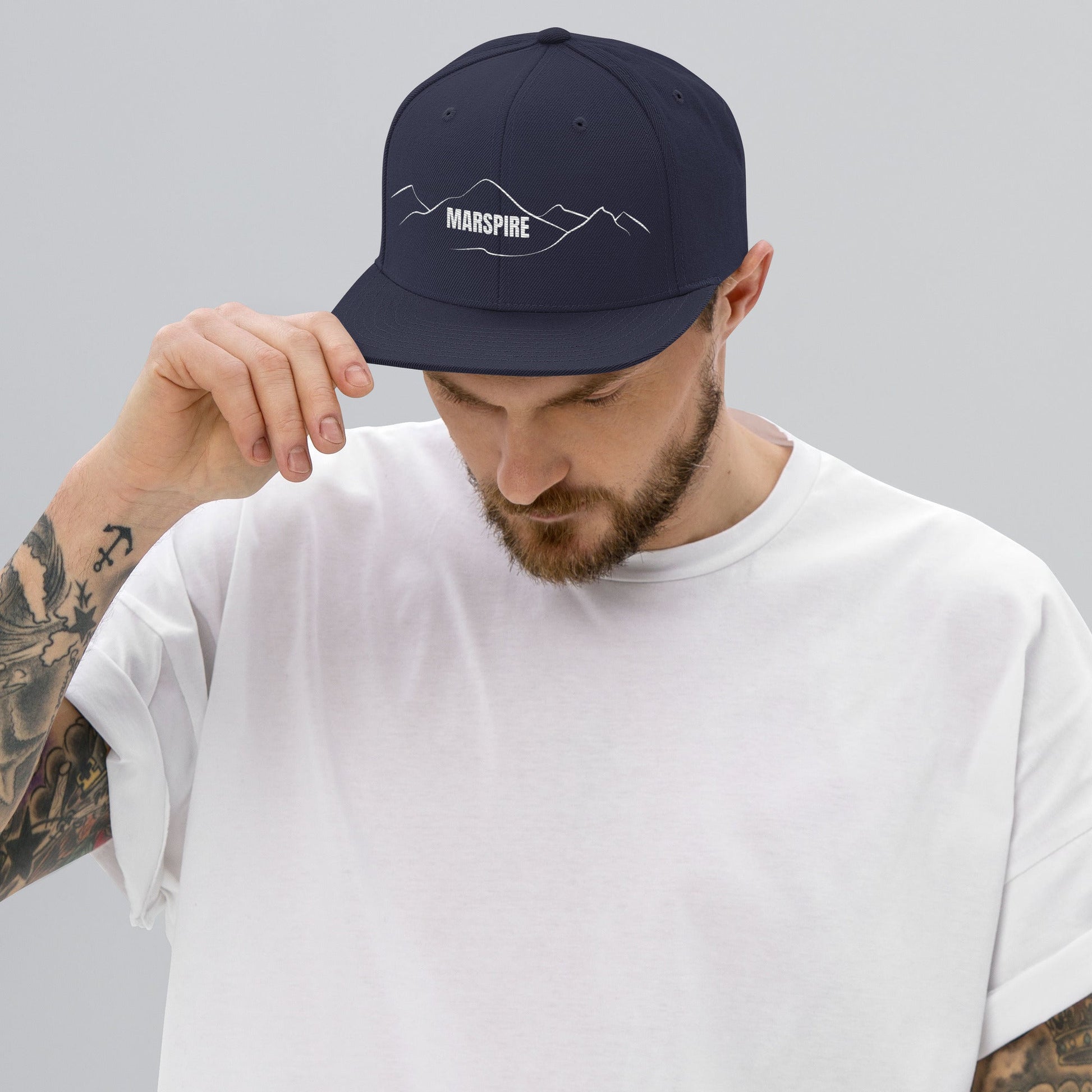 person wearing navy vintage snapback hat