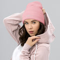 person wearing baby pink beanie hat