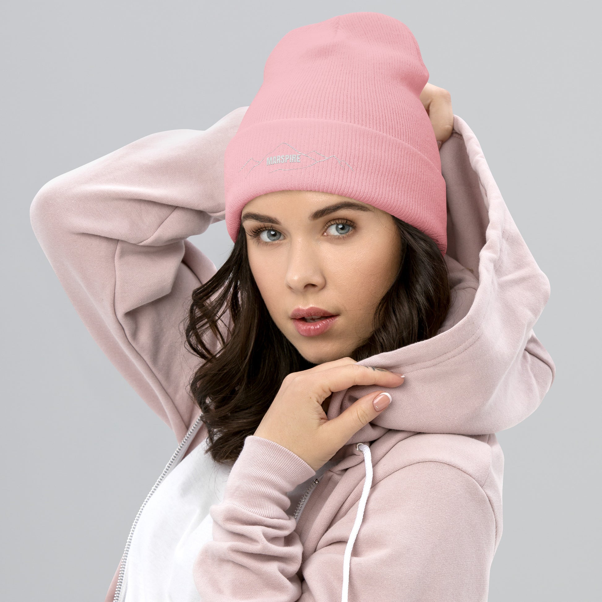 person wearing baby pink beanie hat