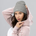 person wearing heather grey beanie hat