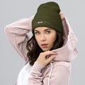 person wearing olive beanie hat