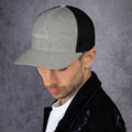 left view of heather & black mesh trucker cap