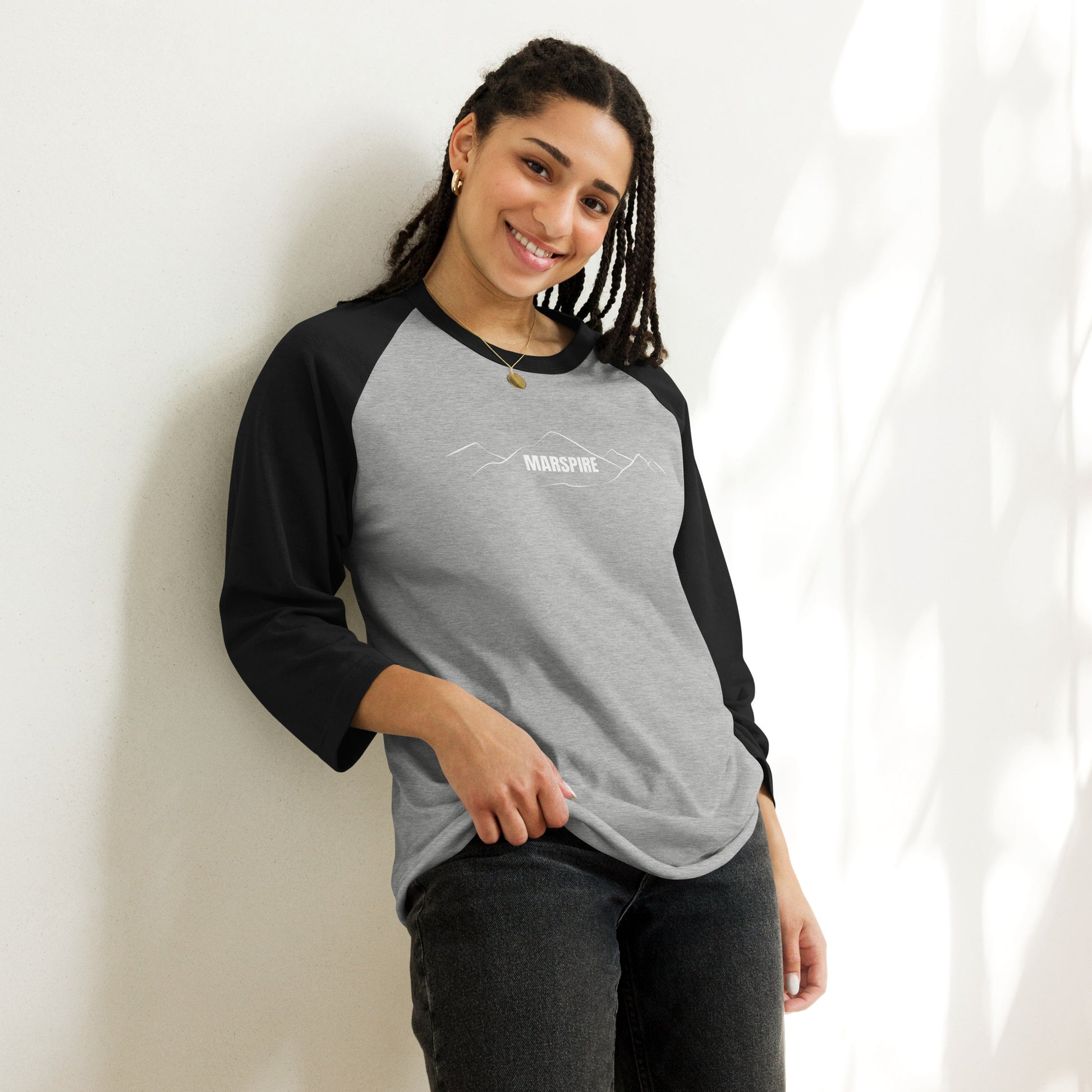 person wearing heather grey & black raglan tee shirts
