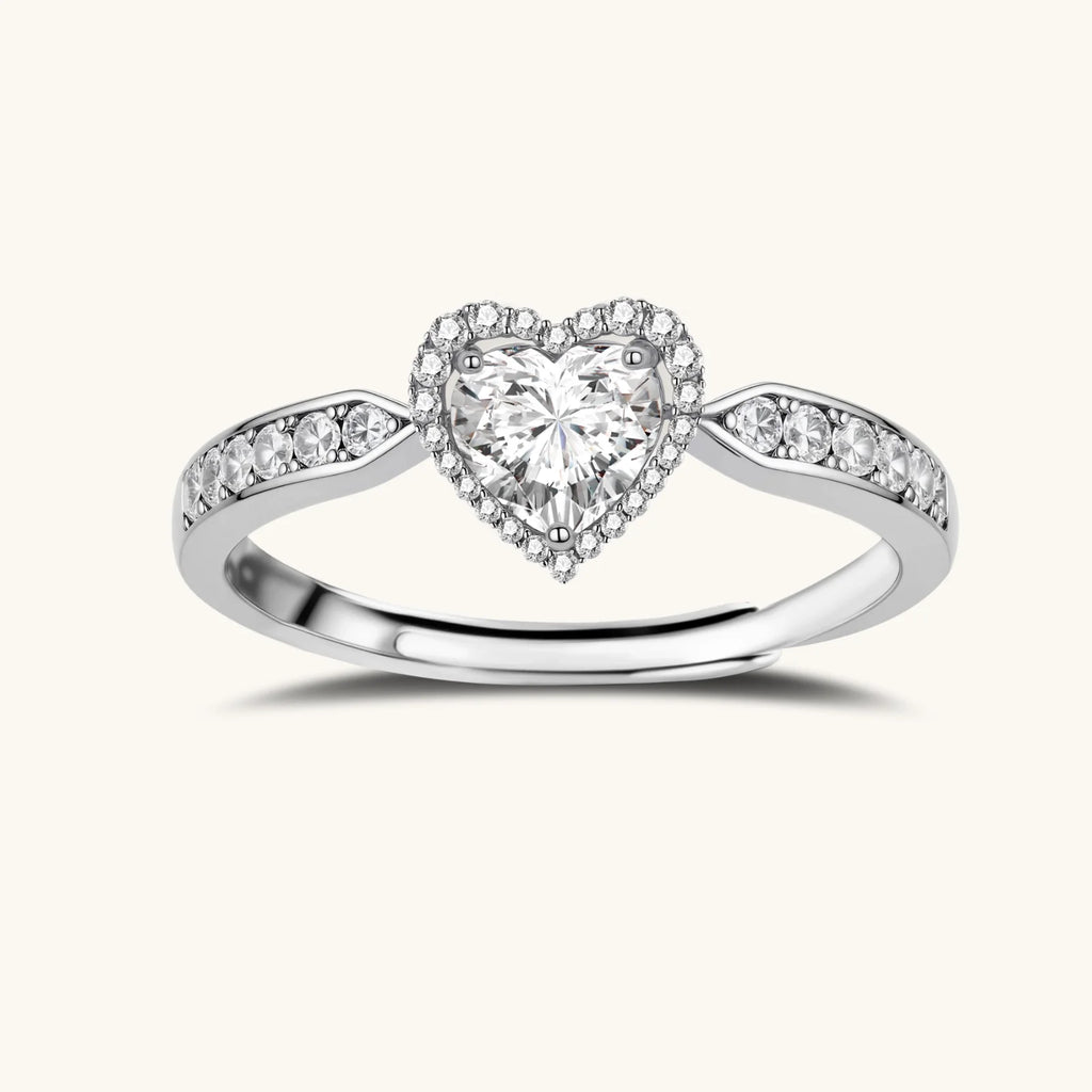 Complete jewelry set with heart-shaped sterling silver pieces featuring brilliant moissanite stones on white background.