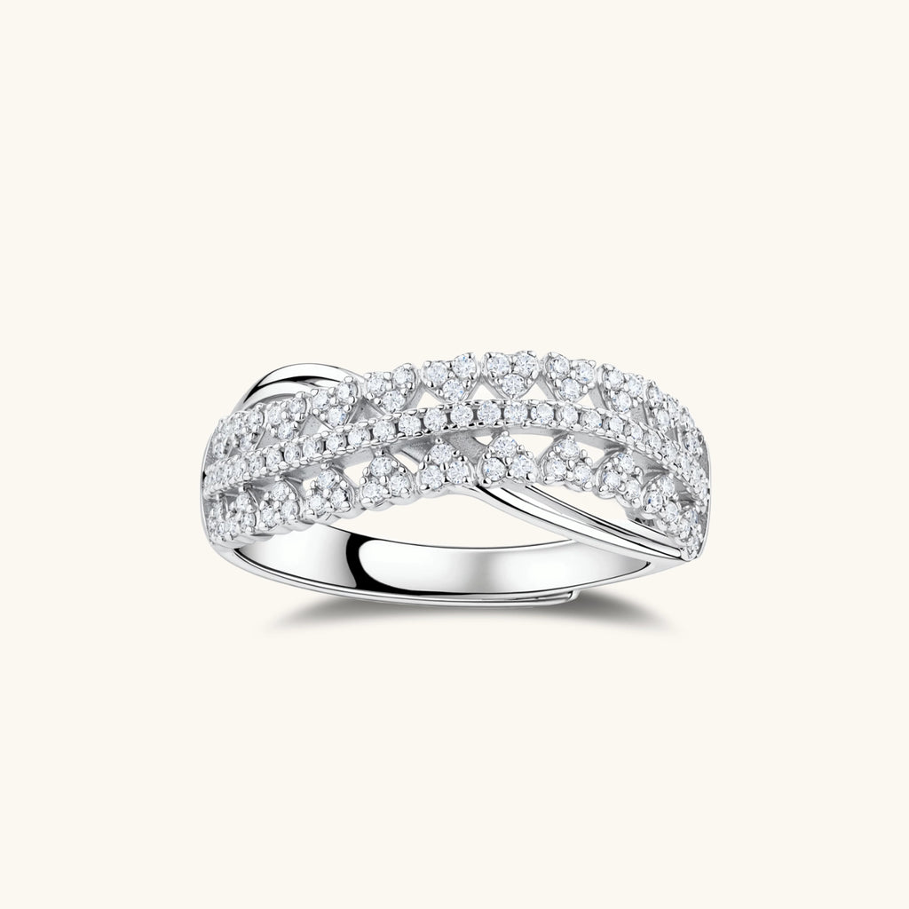 Sterling silver crossover ring with pavé-set moissanite stones creating an elegant infinity design on neutral background