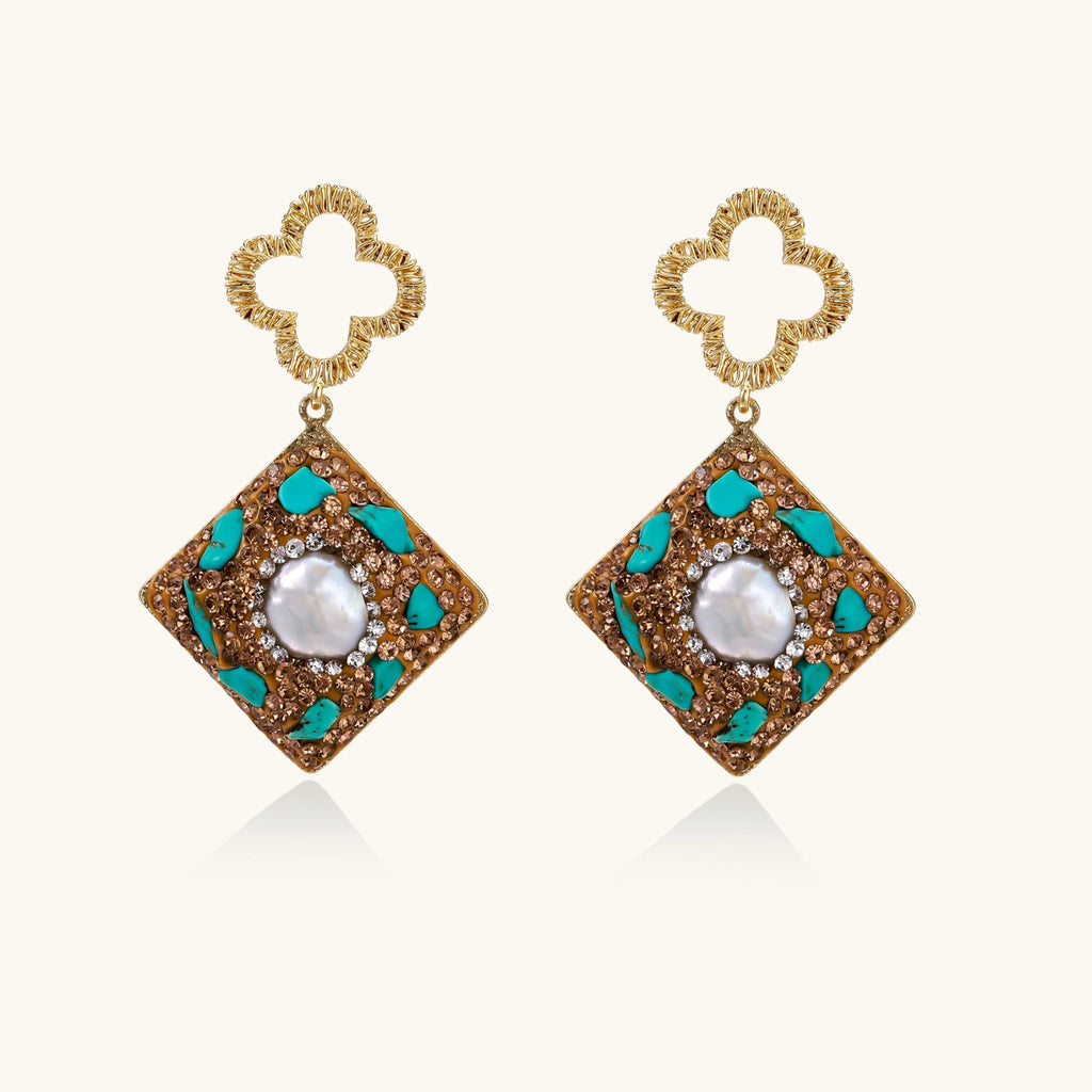 Gold-plated drop earrings with quatrefoil studs, diamond-shaped pendants featuring baroque pearls, turquoise stones, and amber crystals