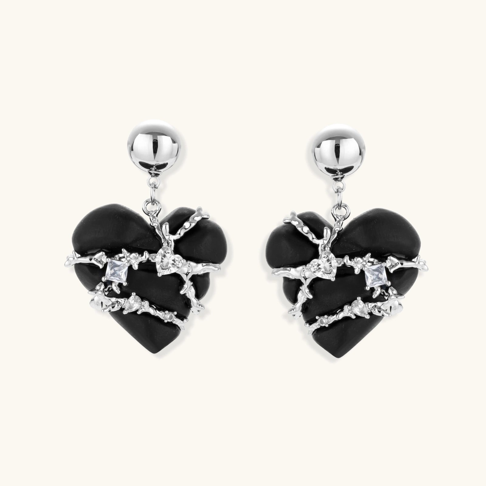 Heart-shaped wood earrings wrapped in silver wire with zirconia crystals, featuring ball stud posts on white background.