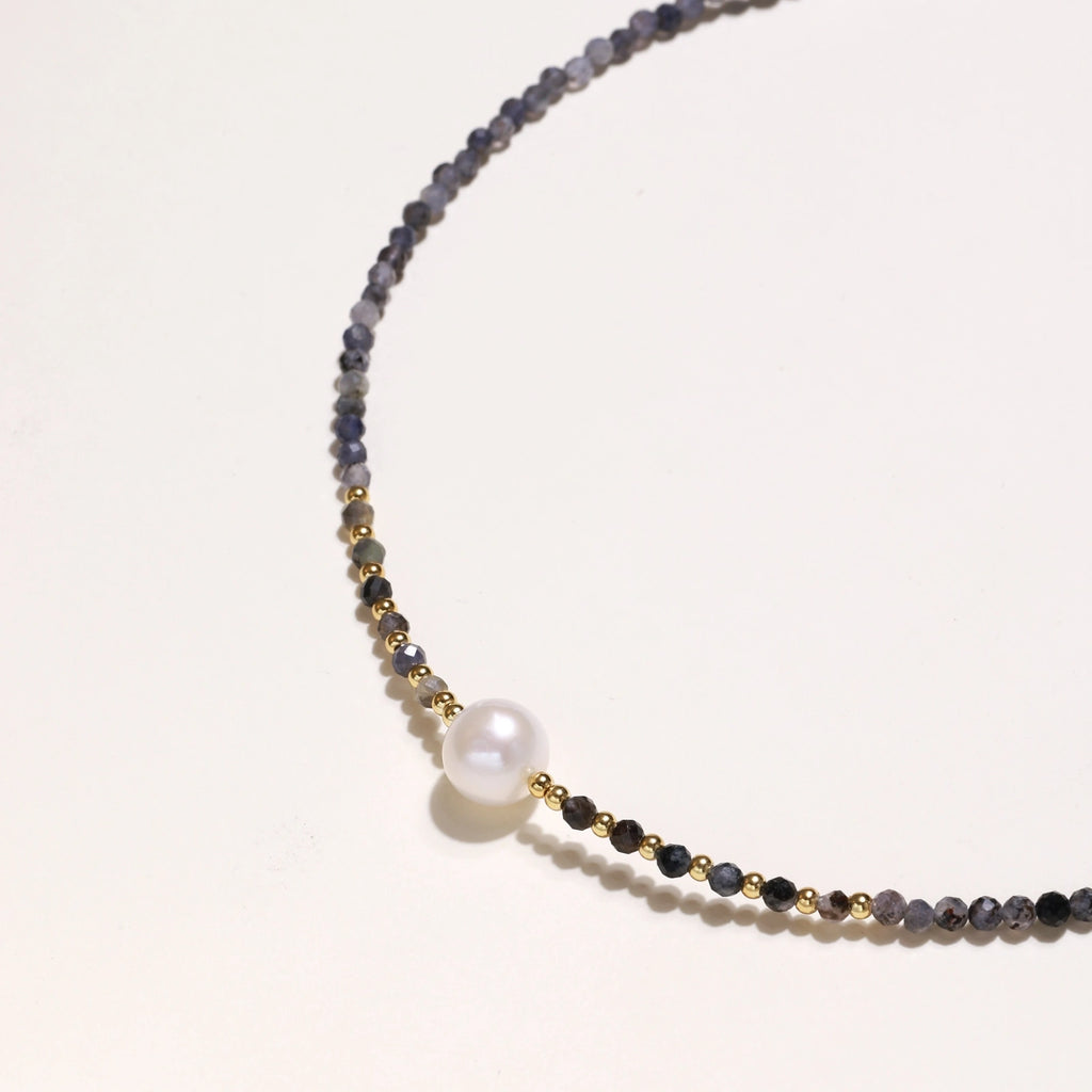 Dainty necklace with faceted purple iolite beads, gold vermeil accents, and central pink-white freshwater pearl.