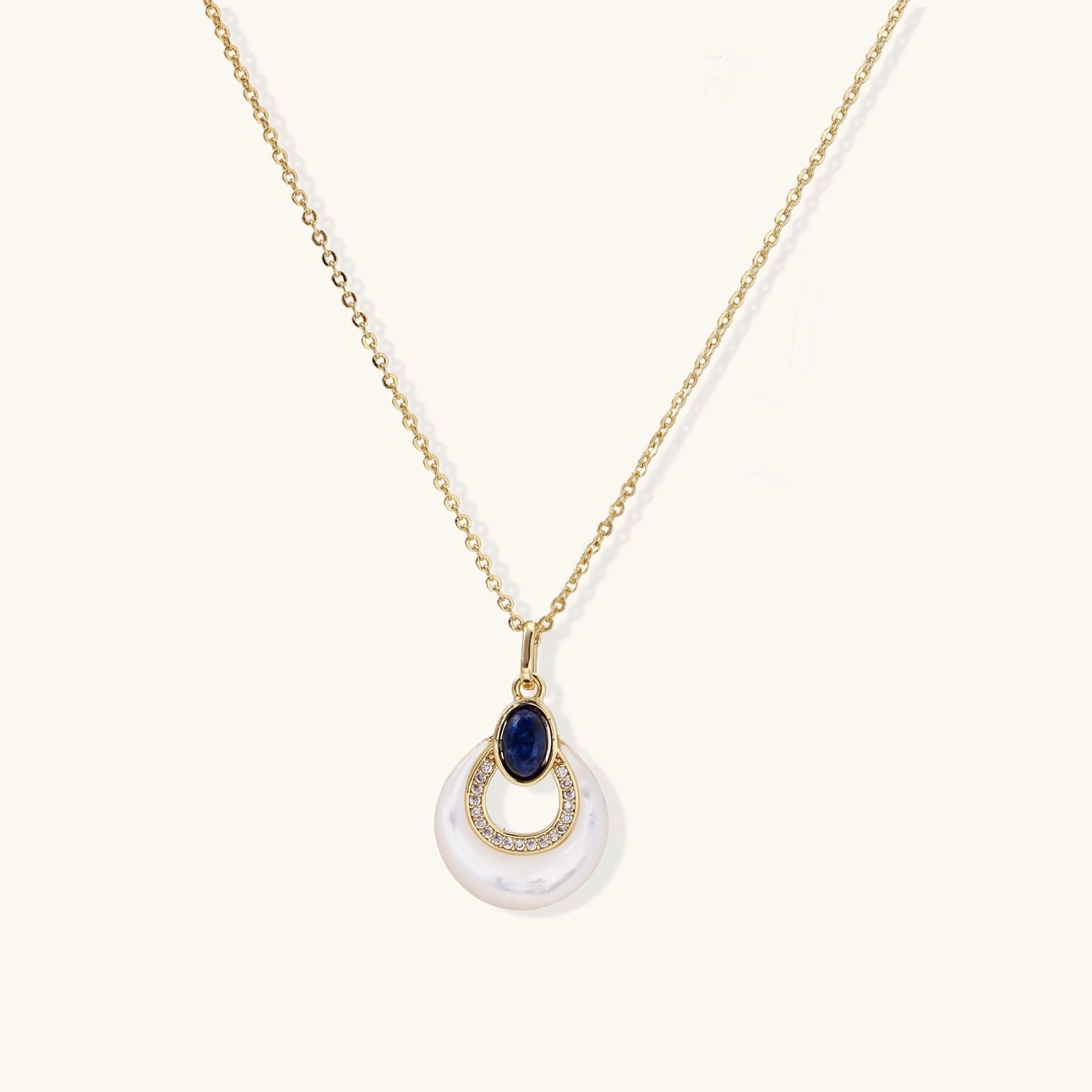 Gold necklace with navy lapis lazuli stone and iridescent mother-of-pearl teardrop pendant with crystal accents