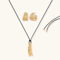 Gold-toned textured pendant necklace with matching hoop earrings featuring organic flowing patterns on white background.
