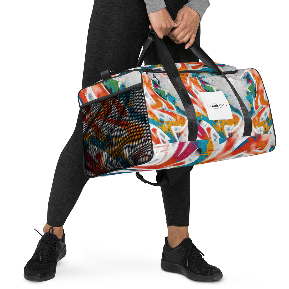 man carrying a large duffle bag