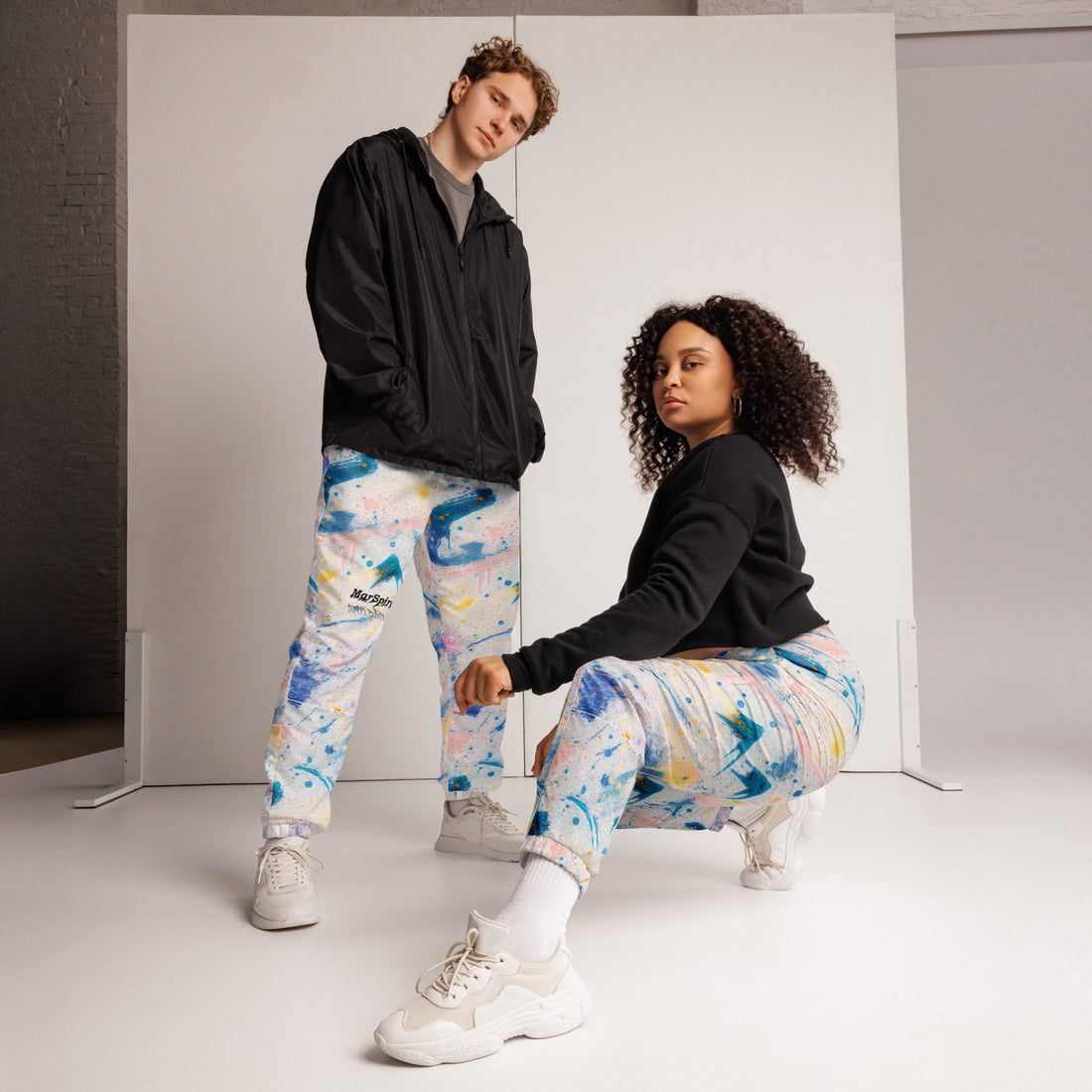 man and woman wearing track sweatpants