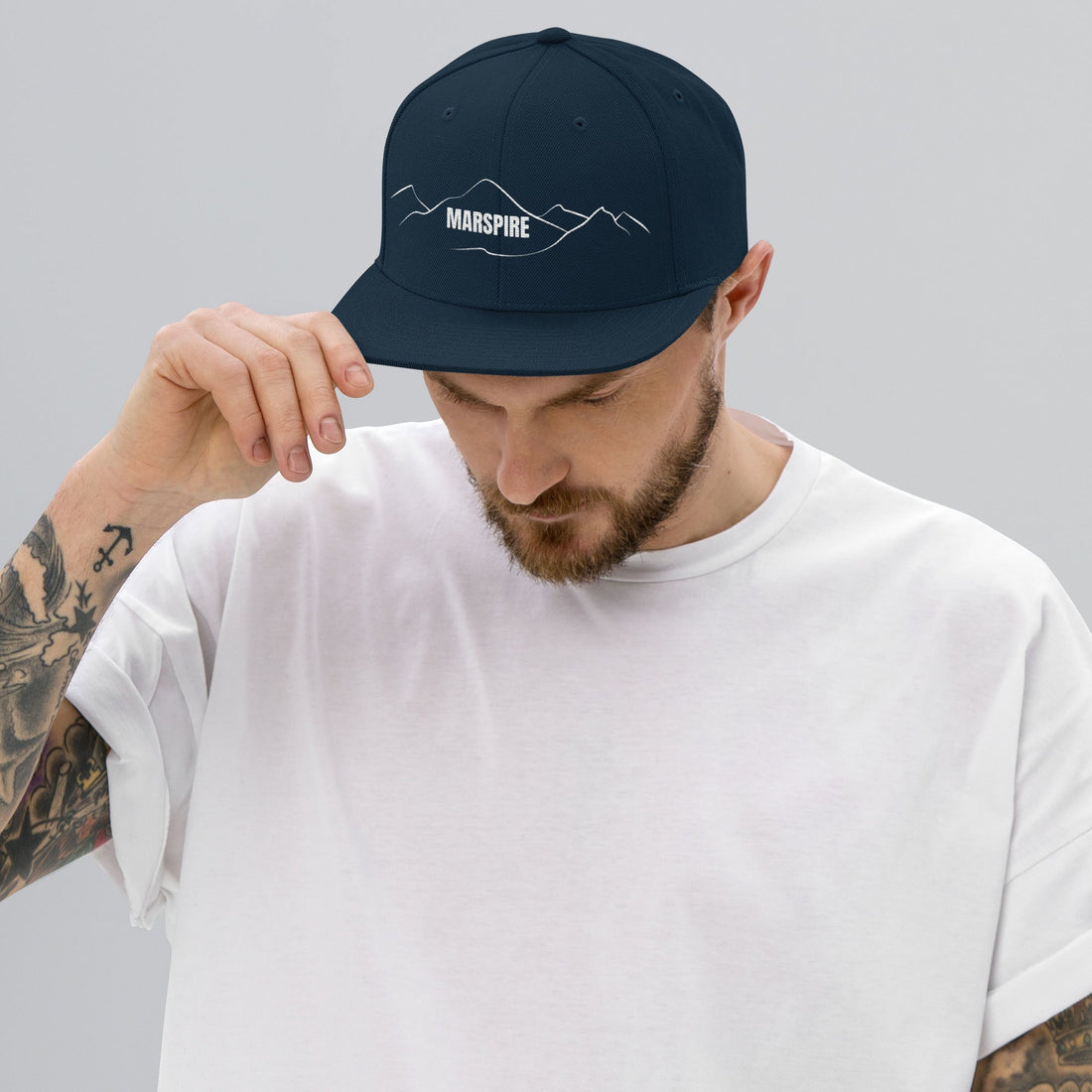 person wearing dark navy vintage snapback hat