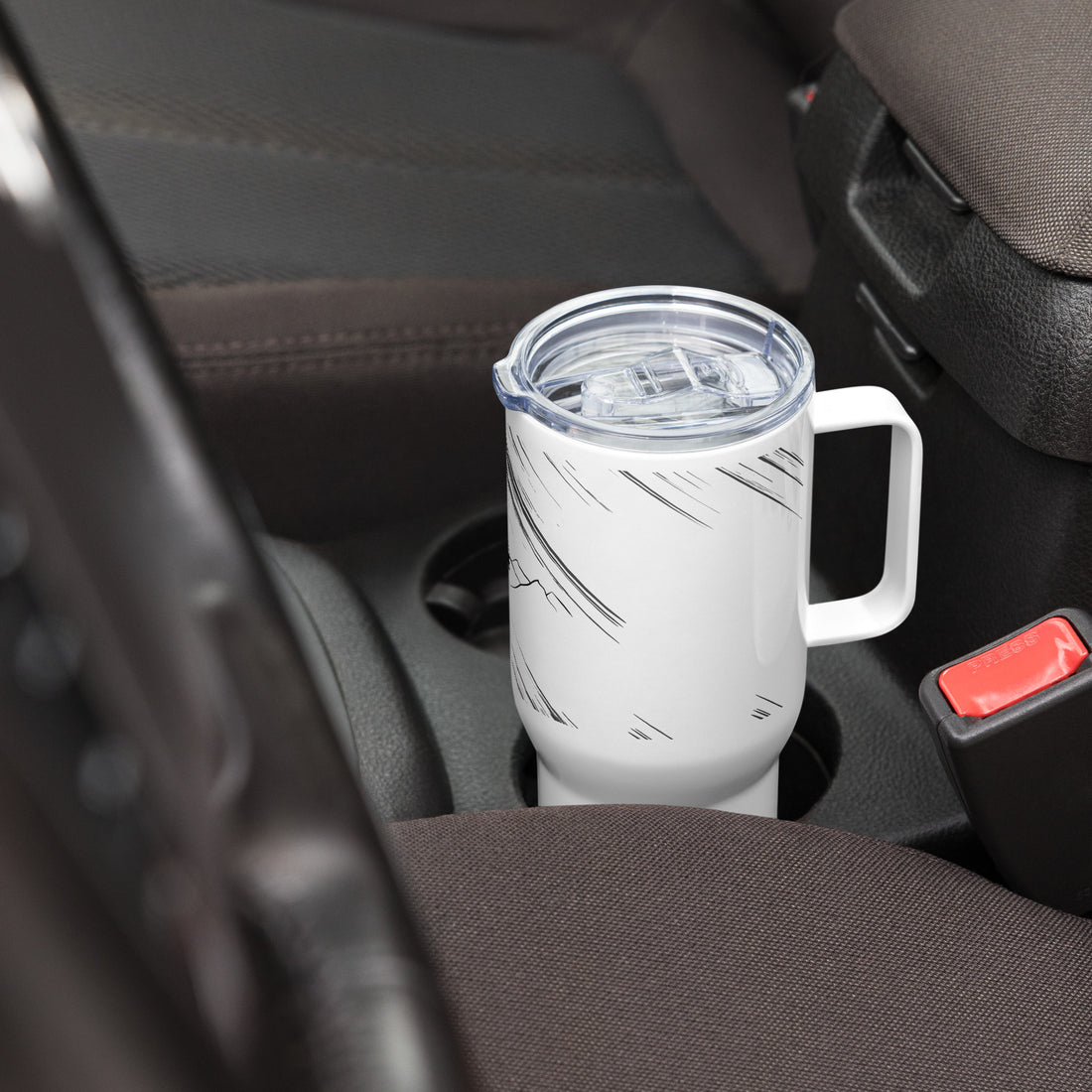 travel mug with a handle resting on car cup holder