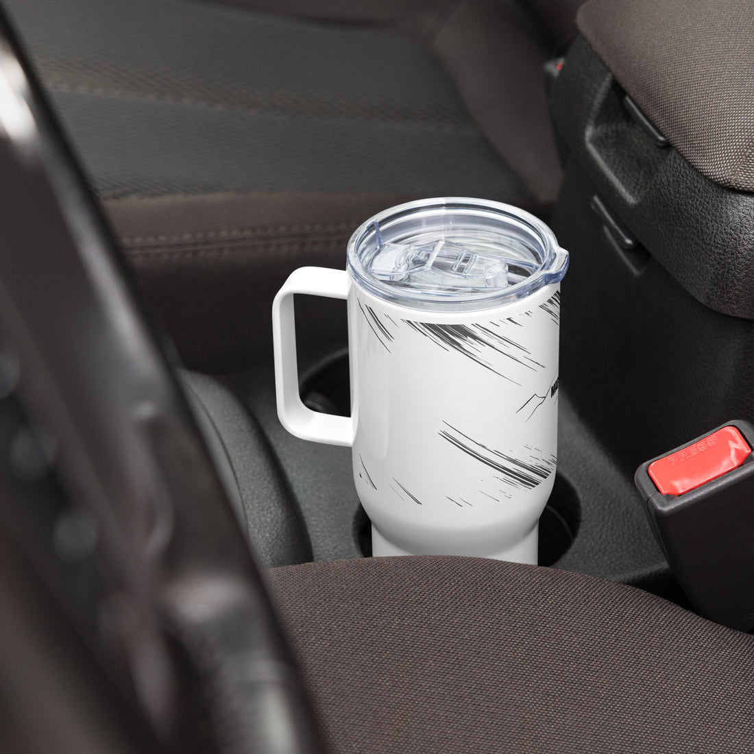 travel mug with a handle resting on car cup holder